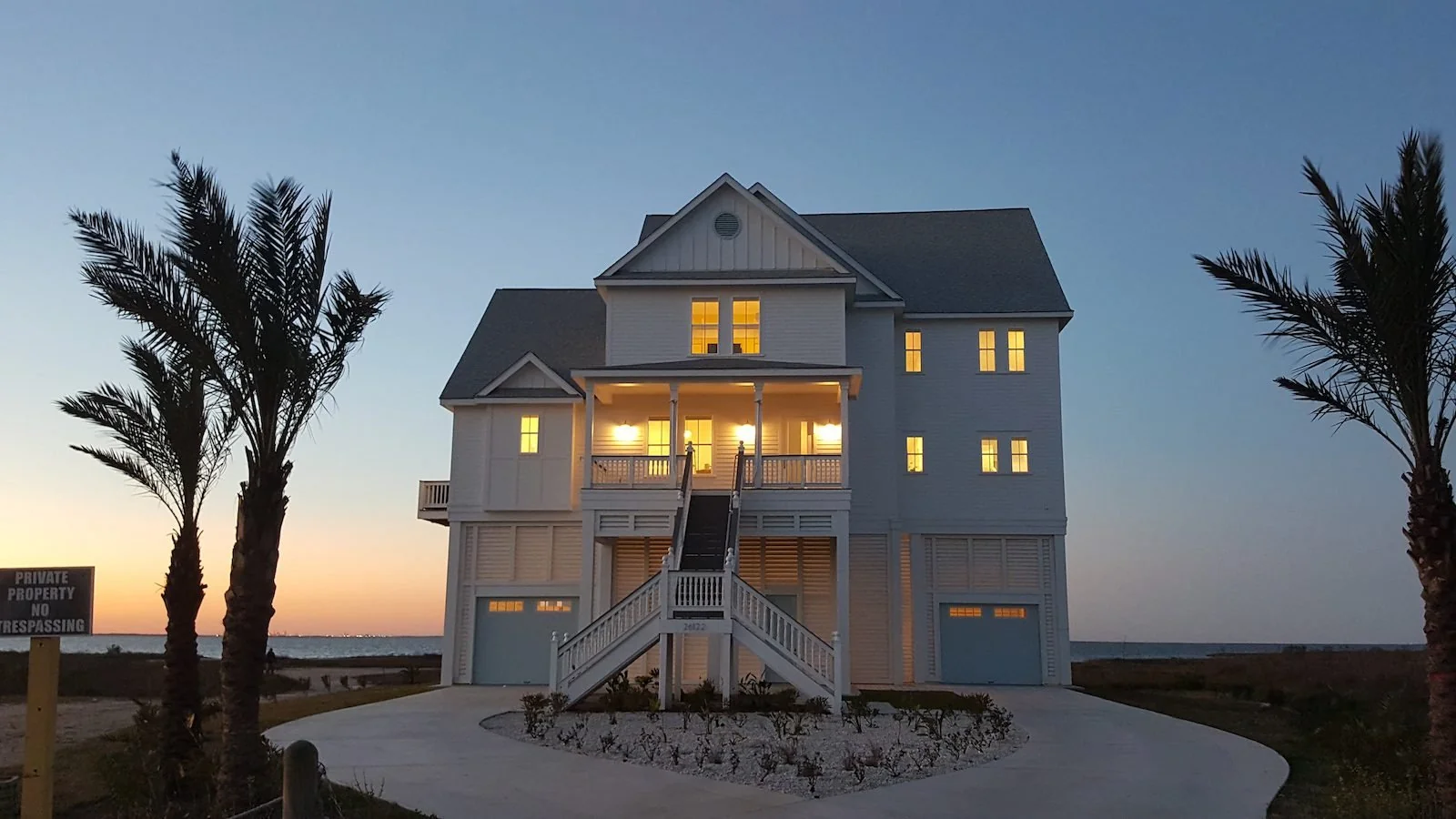 Heaven on Bay luxury home at twilight with illuminated porches