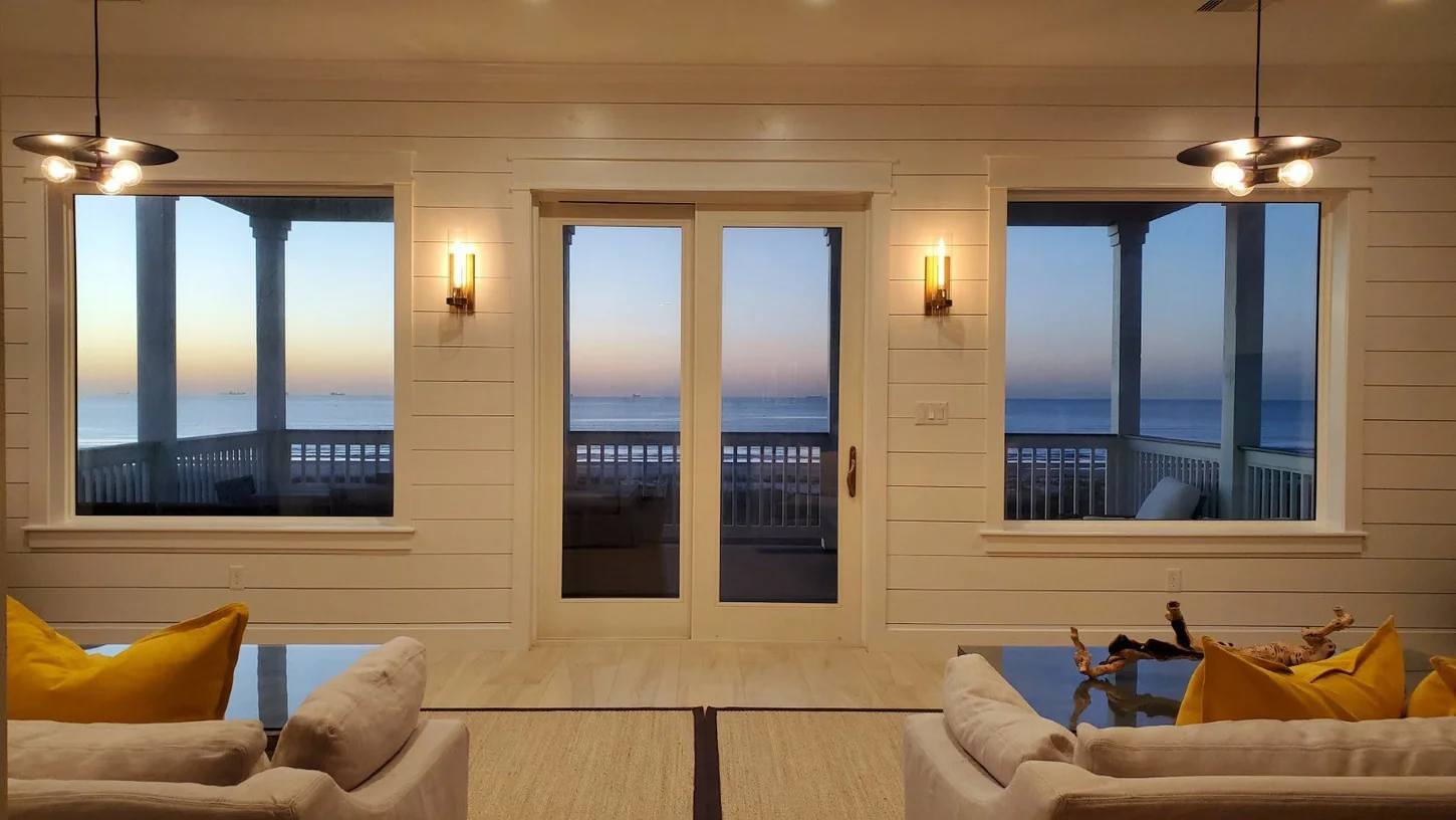 Warmly lit living room at Wilde Dunes with views out to the Gulf