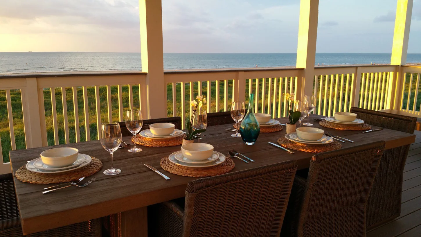 Dinner set on the outdoor deck with a Gulf view at Wilde Dunes
